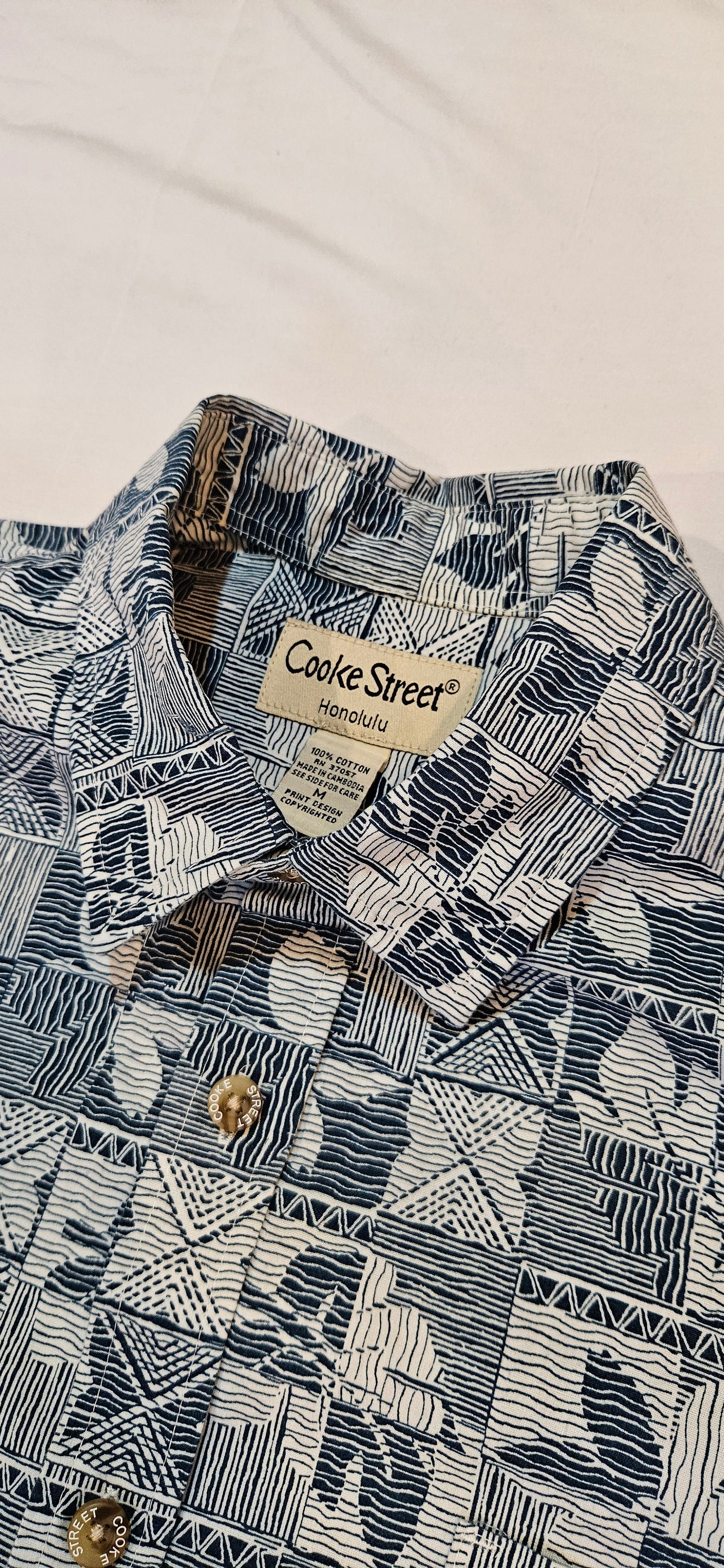 Patterned shirt with a brand label on a light background